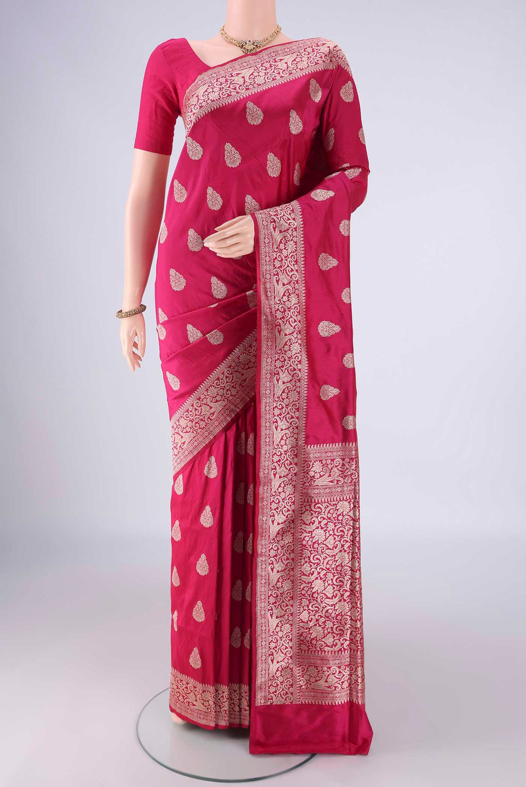 Dark Pink Banarasi Silk Saree with Zari Butta on the body and Zari Border.  displayed on a mannequin