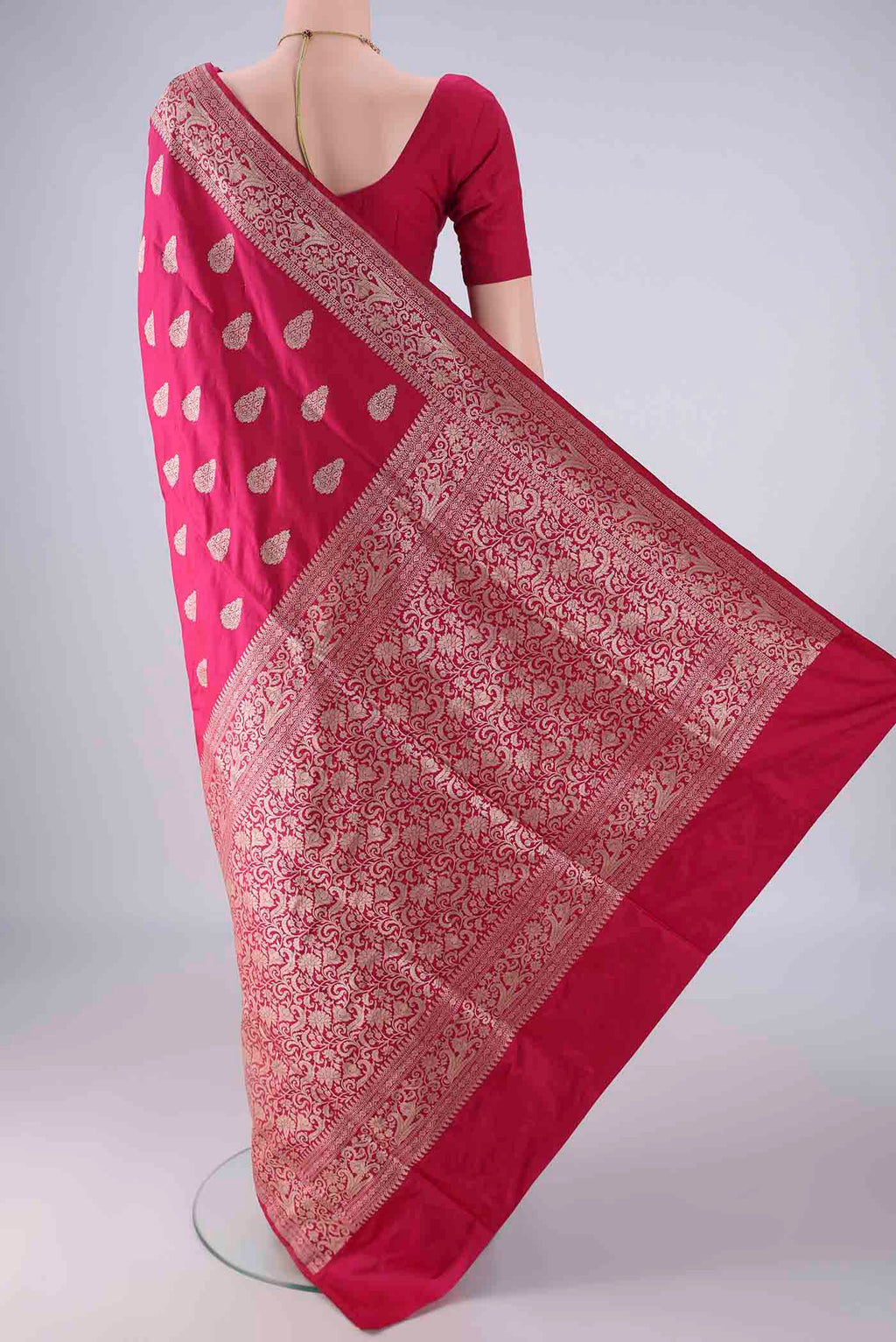 Flat view of Dark Pink Banarasi Silk Saree with Zari Butta on the body and Zari Border. 