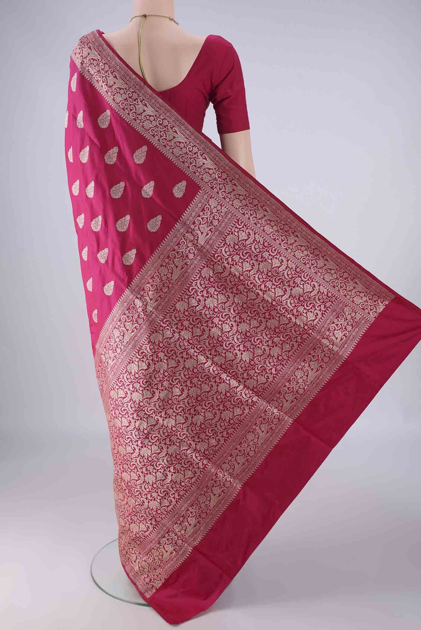 Flat view of Dark Pink Banarasi Silk Saree with Zari Butta on the body and Zari Border. 