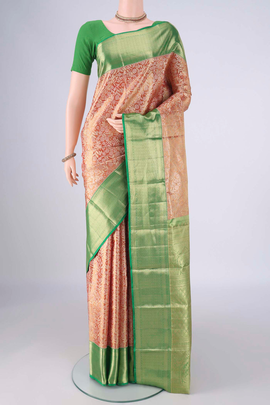 Golden Dual Tone Kanchipuram Tissue Silk Saree with Zari Brocade on the body and Zari Border.  displayed on a mannequin