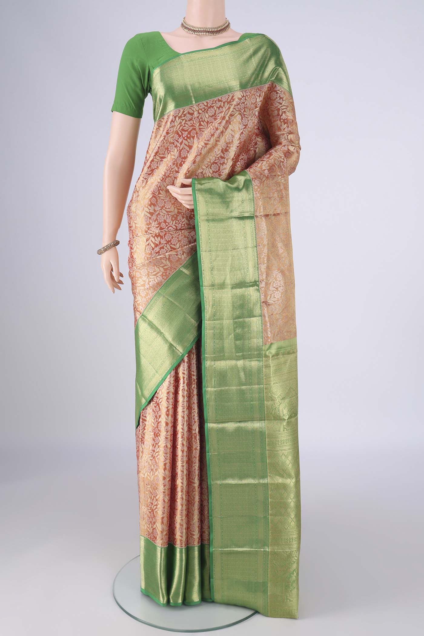 Golden Dual Tone Kanchipuram Tissue Silk Saree with Zari Brocade on the body and Zari Border.  displayed on a mannequin