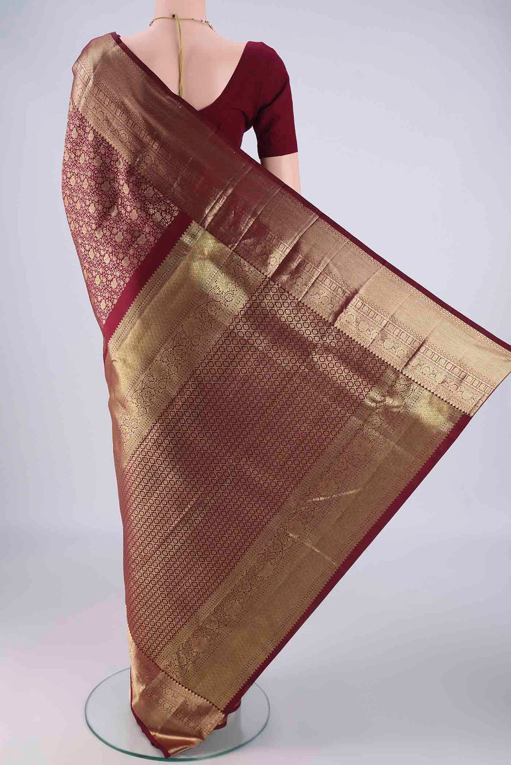 Flat view of Maroon Kanchipuram Silk Saree with Zari Brocade on the body and Zari Border. 
