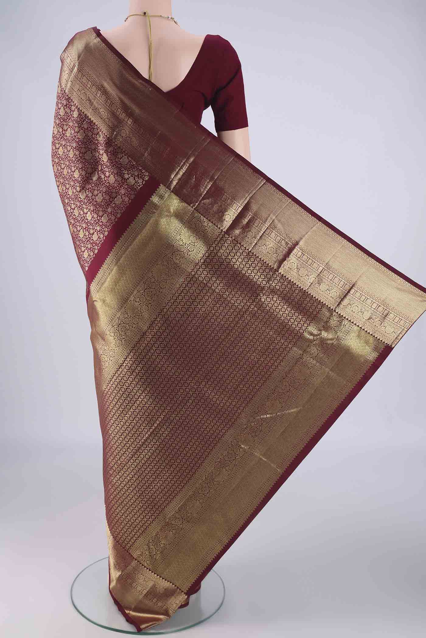 Flat view of Maroon Kanchipuram Silk Saree with Zari Brocade on the body and Zari Border. 