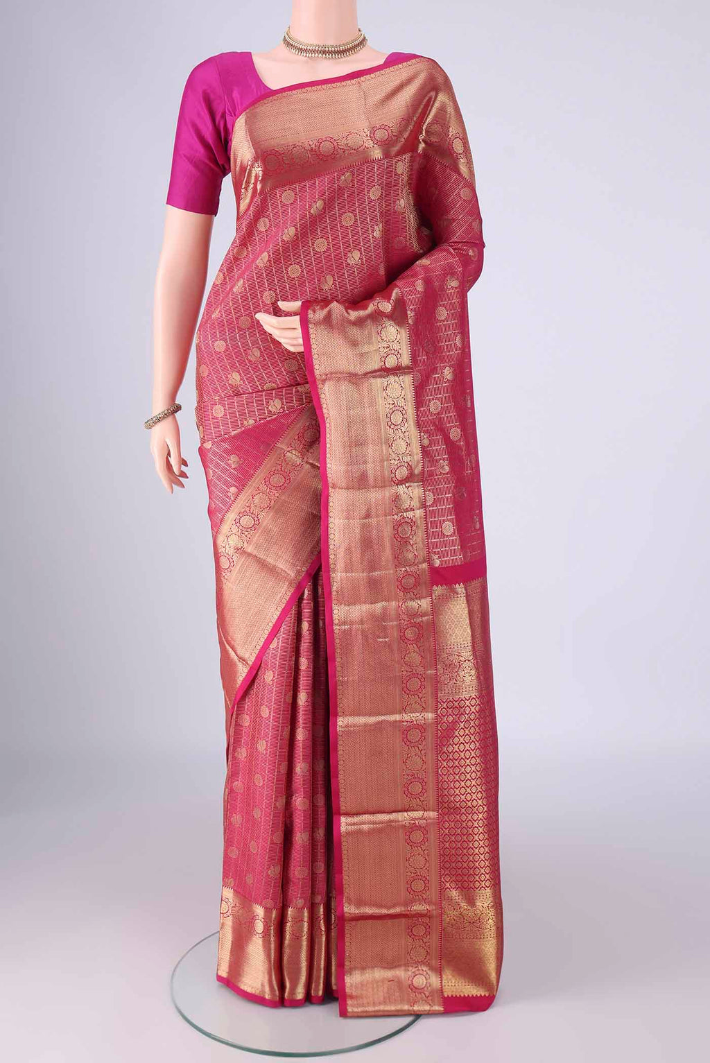 Rani Pink Kanchipuram Tissue Silk Saree with Zari Brocade on the body and Zari Border.  displayed on a mannequin