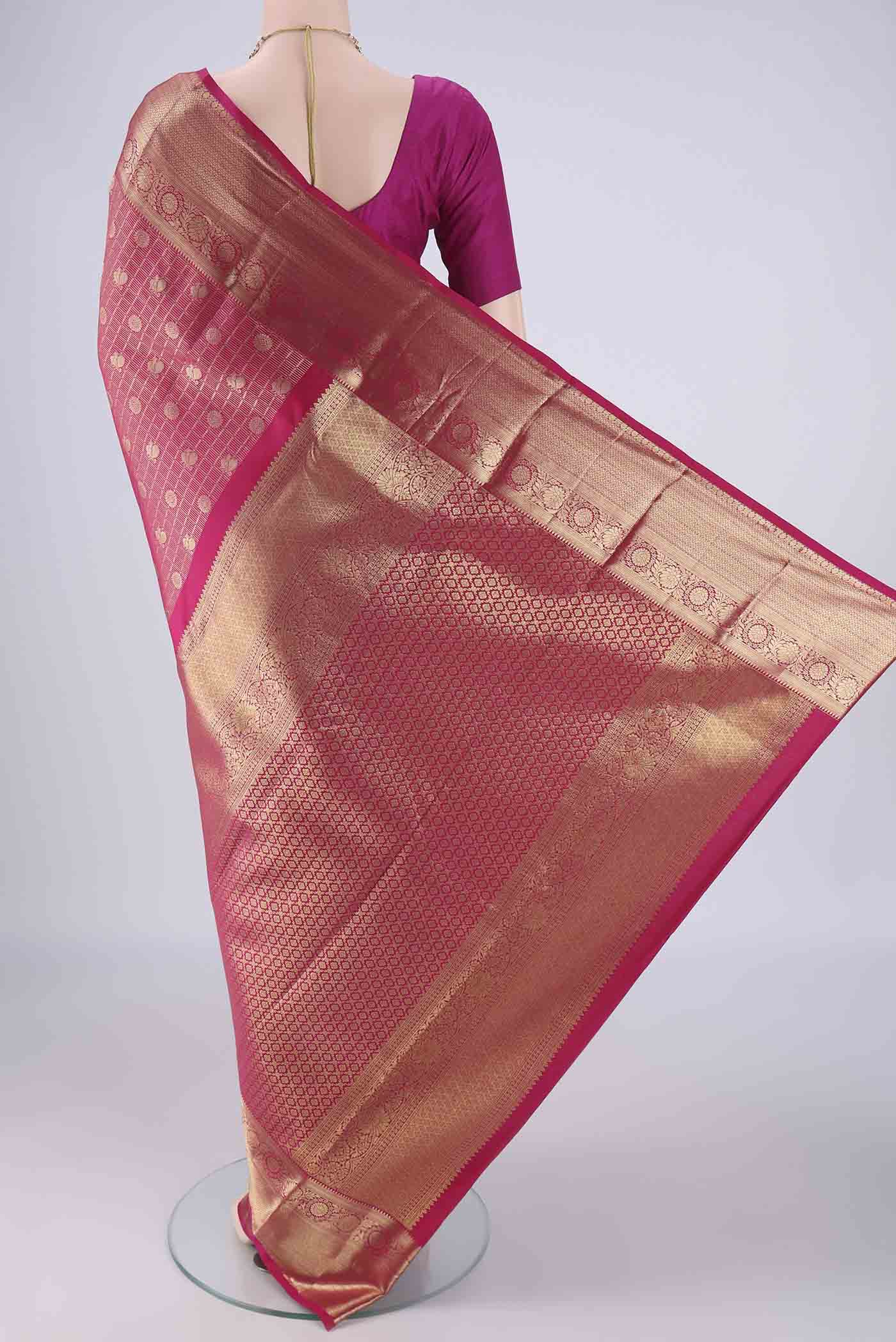 Flat view of Rani Pink Kanchipuram Tissue Silk Saree with Zari Brocade on the body and Zari Border. 