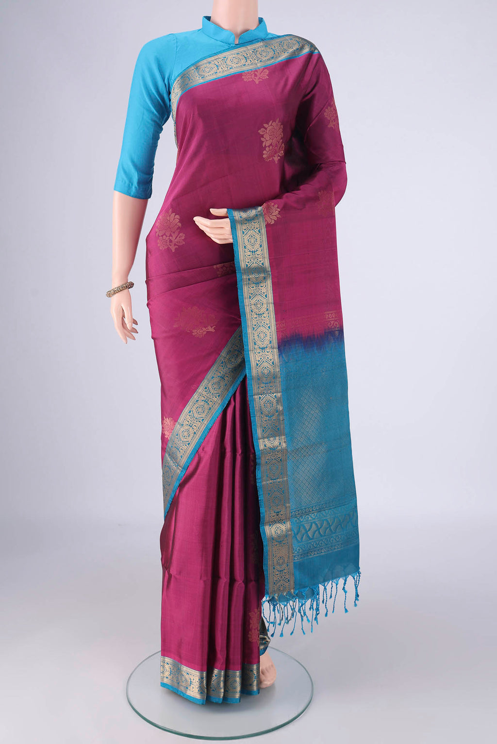 Magenta Soft Silk Saree with Zari Butta on the body and Zari Border.  displayed on a mannequin