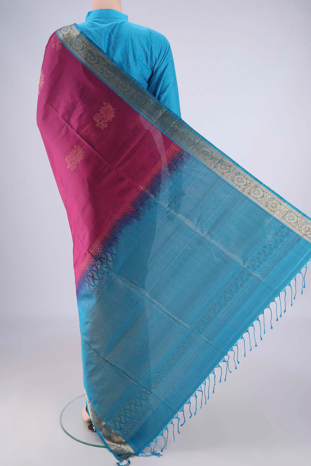 Flat view of Magenta Soft Silk Saree with Zari Butta on the body and Zari Border. 