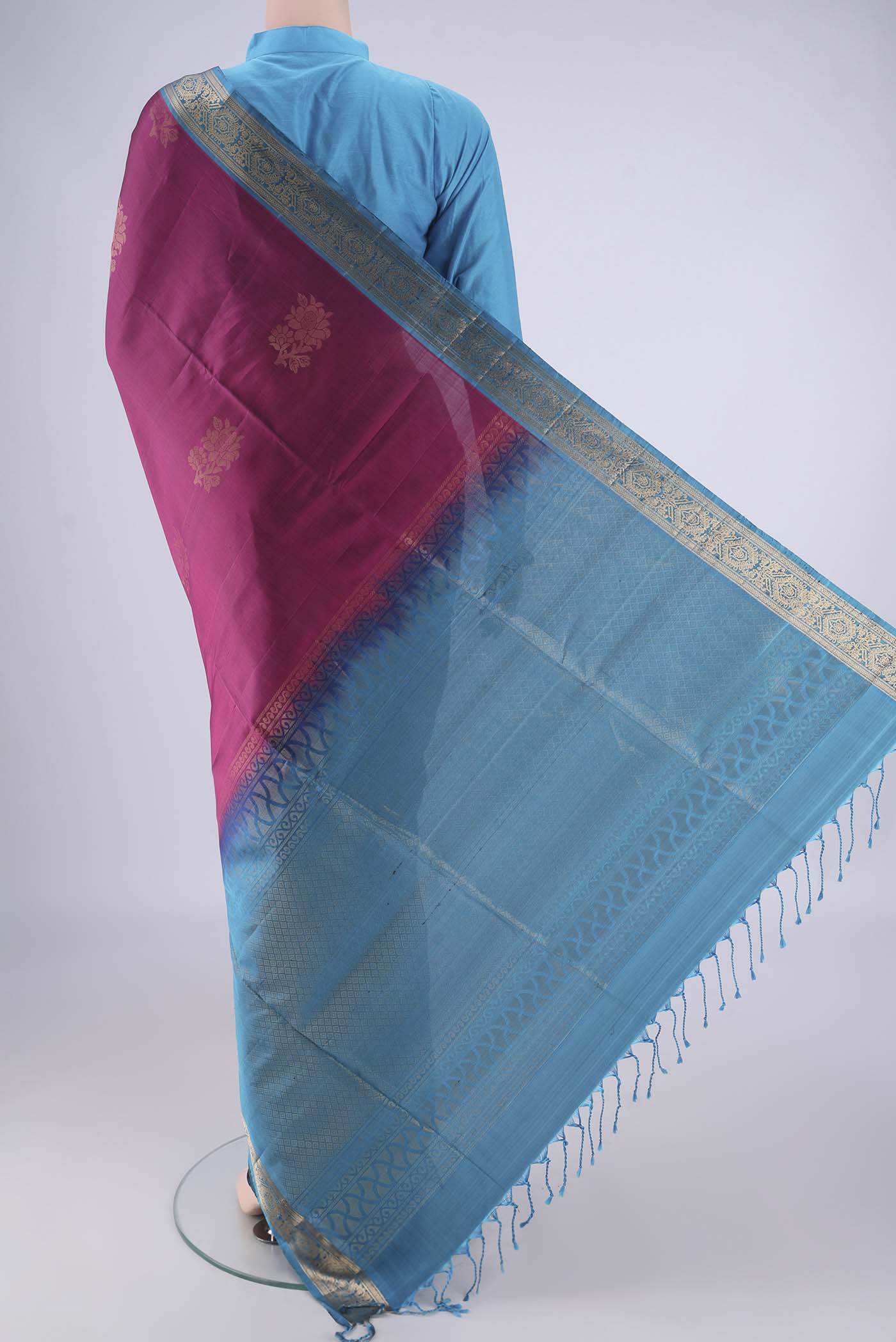 Flat view of Magenta Soft Silk Saree with Zari Butta on the body and Zari Border. 