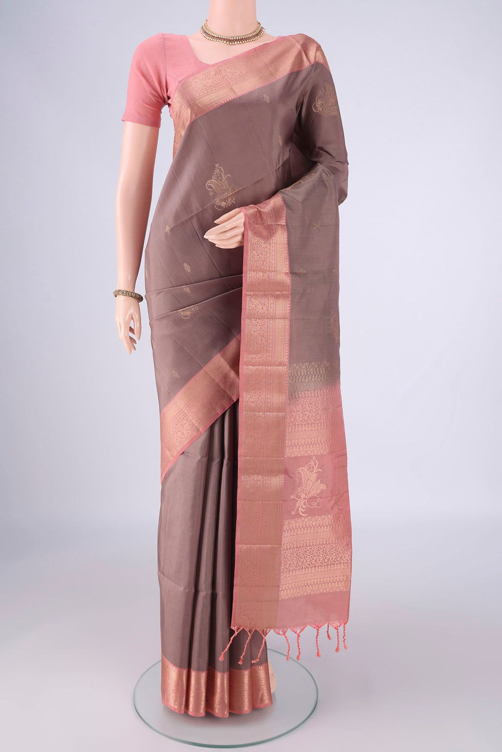 Mauve Soft Silk Saree with Zari Butta on the body and Zari Border.  displayed on a mannequin