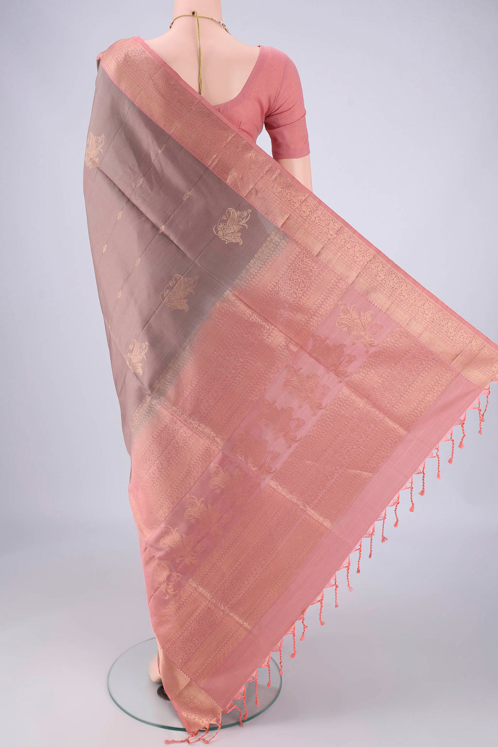 Flat view of Mauve Soft Silk Saree with Zari Butta on the body and Zari Border. 