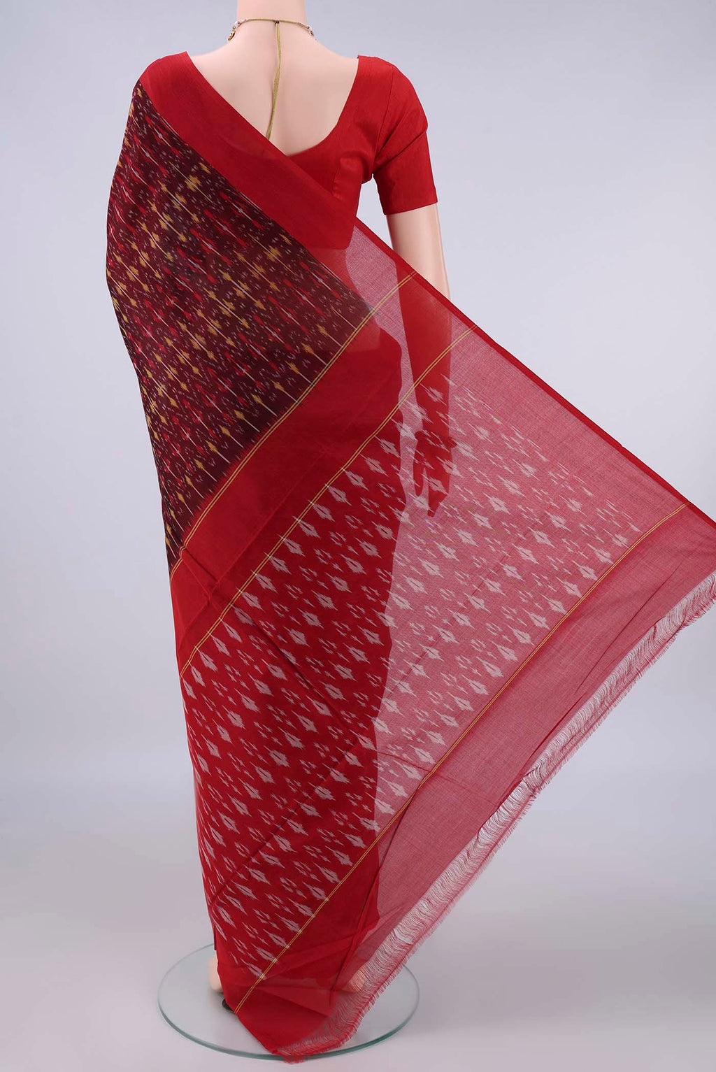 Flat view of Maroon Pochampally Cotton Saree with Ikat design on the body and Ikat Border. 