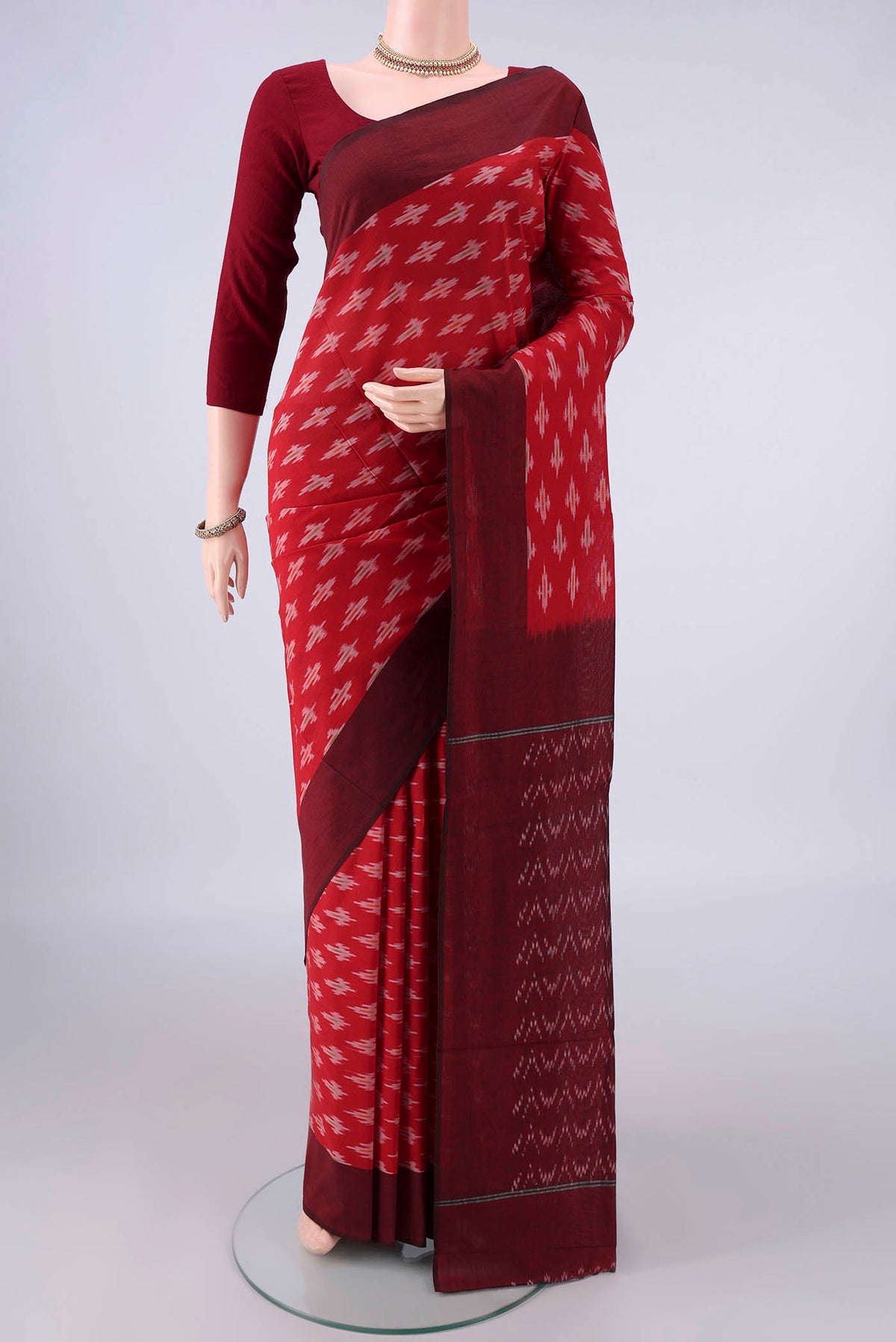 Red Pochampally Cotton Saree with Ikat design on the body and Ikat Border.  displayed on a mannequin