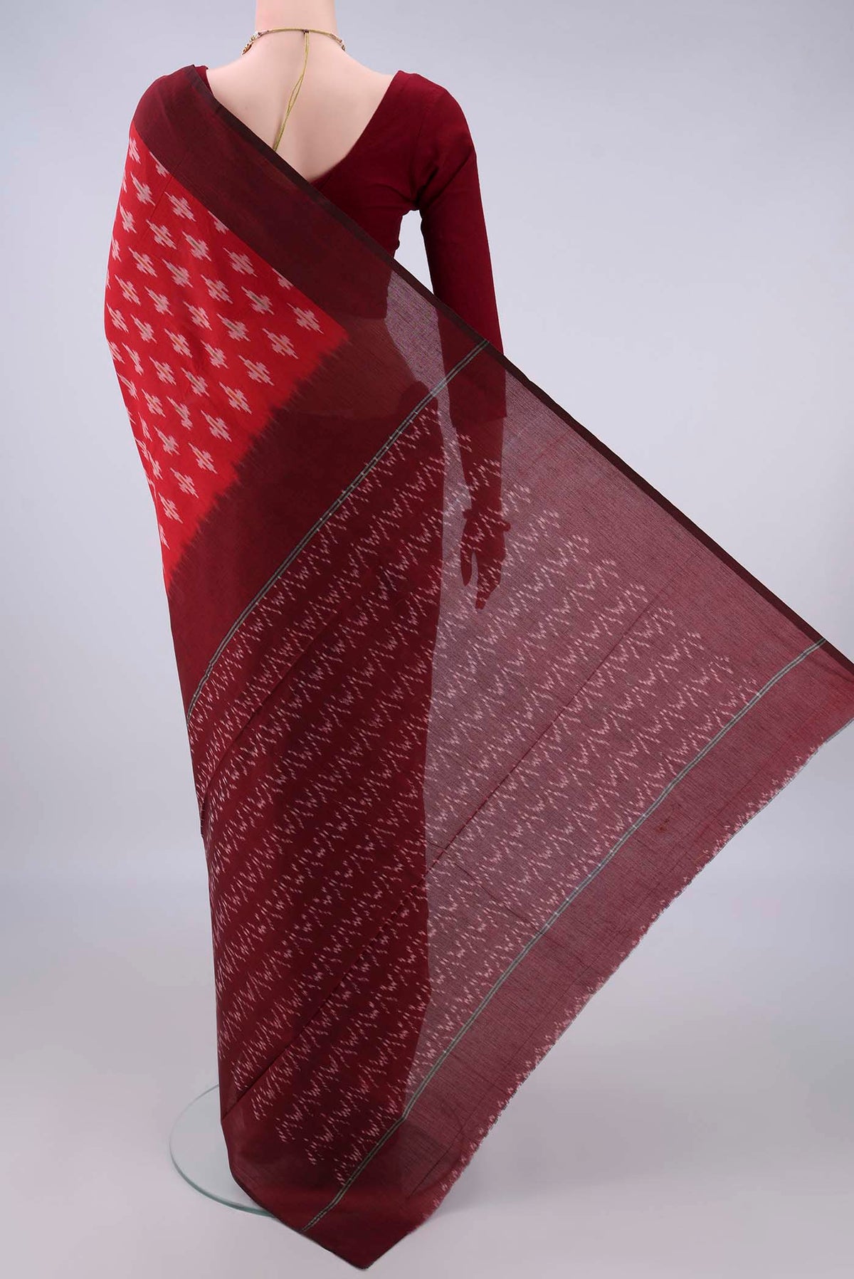 Flat view of Red Pochampally Cotton Saree with Ikat design on the body and Ikat Border. 