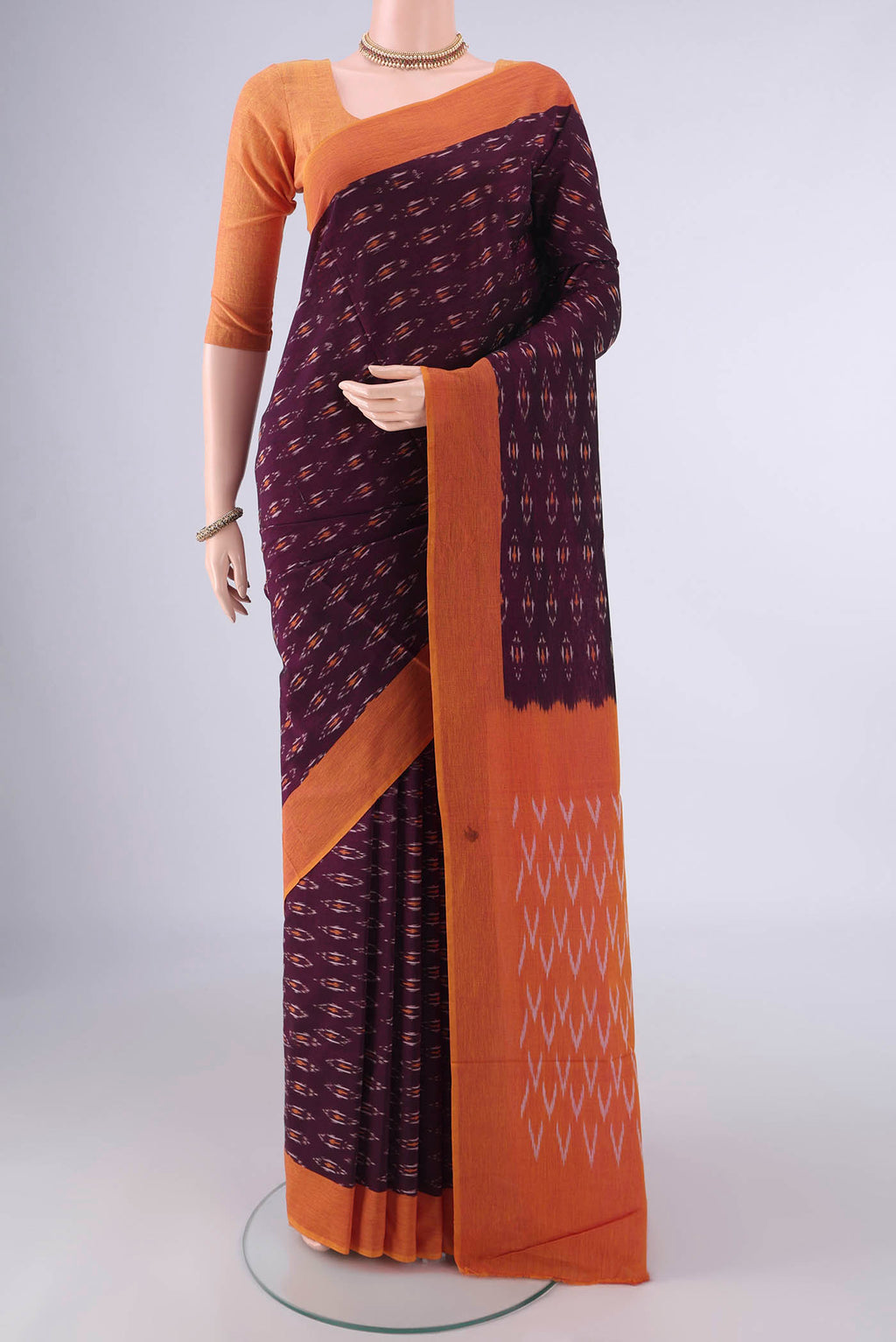 Coffee Brown Pochampally Cotton Saree with Ikat design on the body and Plain Border.  displayed on a mannequin