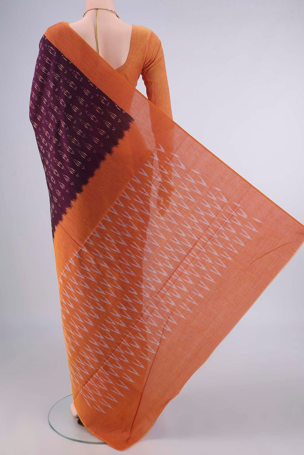 Flat view of Coffee Brown Pochampally Cotton Saree with Ikat design on the body and Plain Border. 