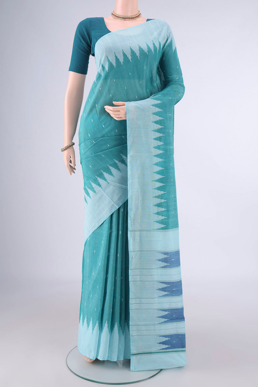 Sea Green Pochampally Cotton Saree with Ikat design on the body and Temple Border.  displayed on a mannequin