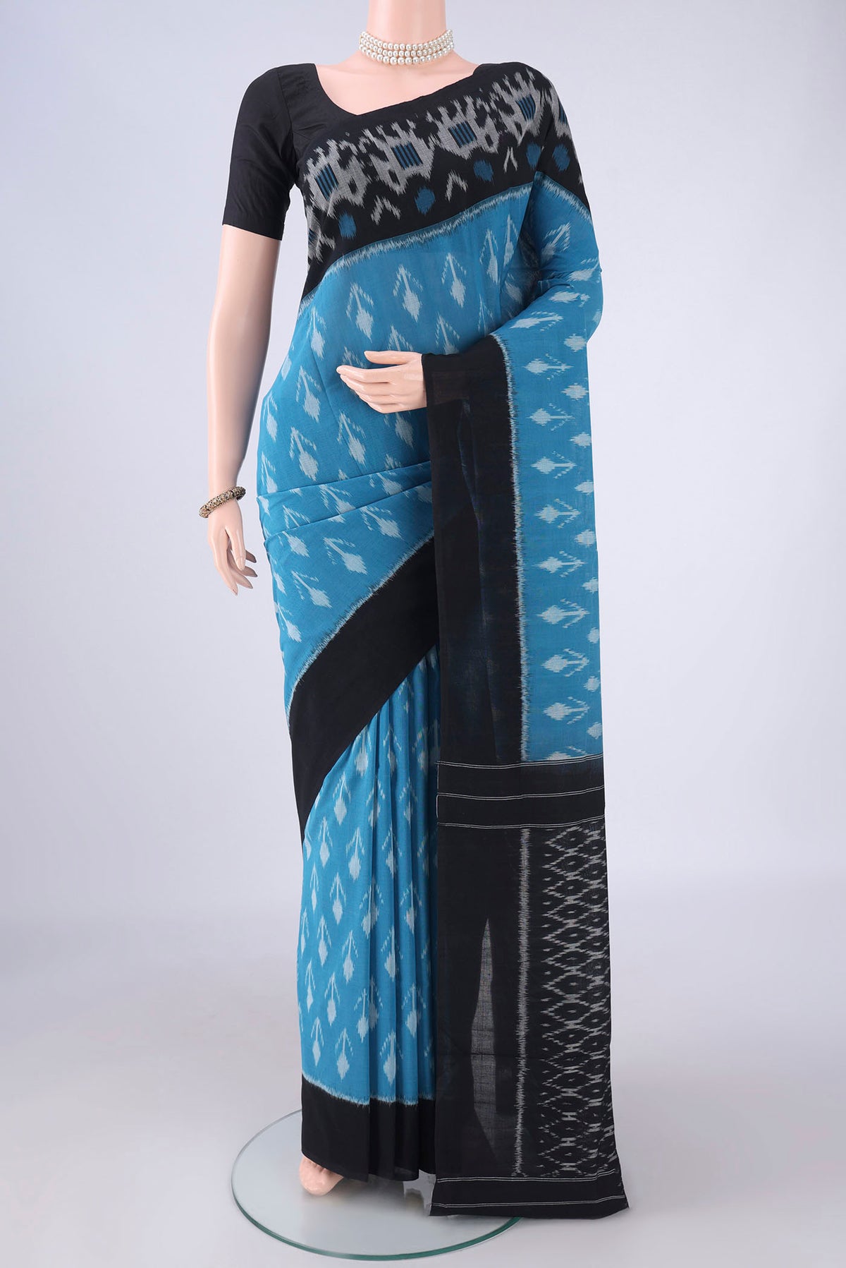 Blue Pochampally Cotton Saree with Ikat design on the body and Ikat Border.  displayed on a mannequin