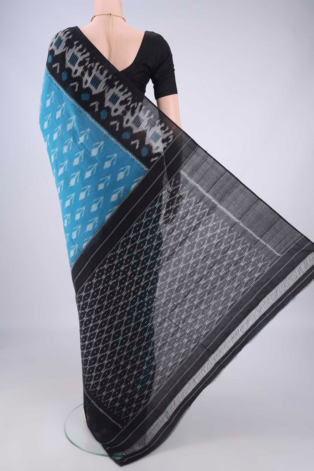 Flat view of Blue Pochampally Cotton Saree with Ikat design on the body and Ikat Border. 