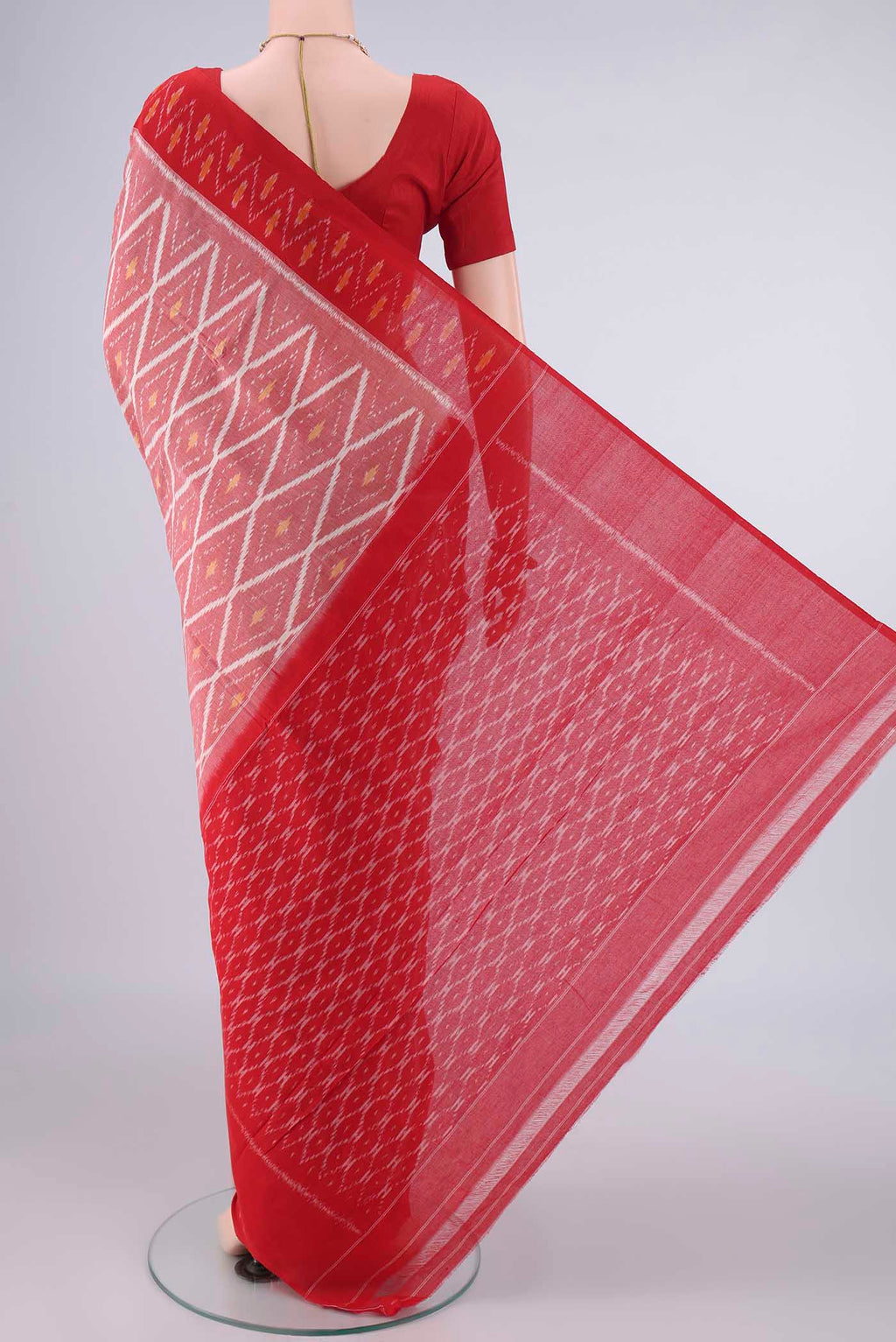 Flat view of Peach Pochampally Cotton Saree with Ikat design on the body and Ikat Border. 
