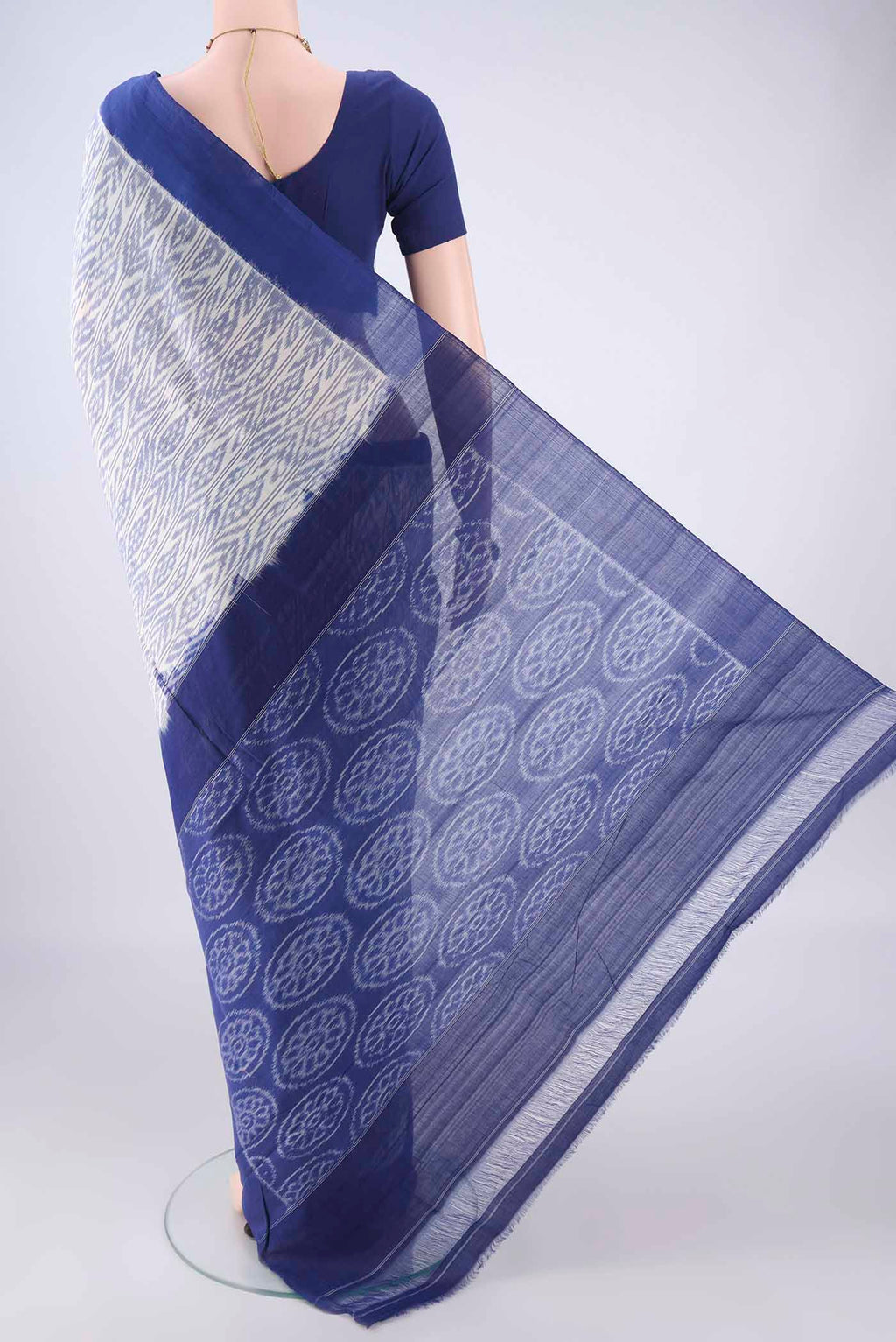Flat view of White Pochampally Cotton Saree with Ikat design on the body and Plain Border. 