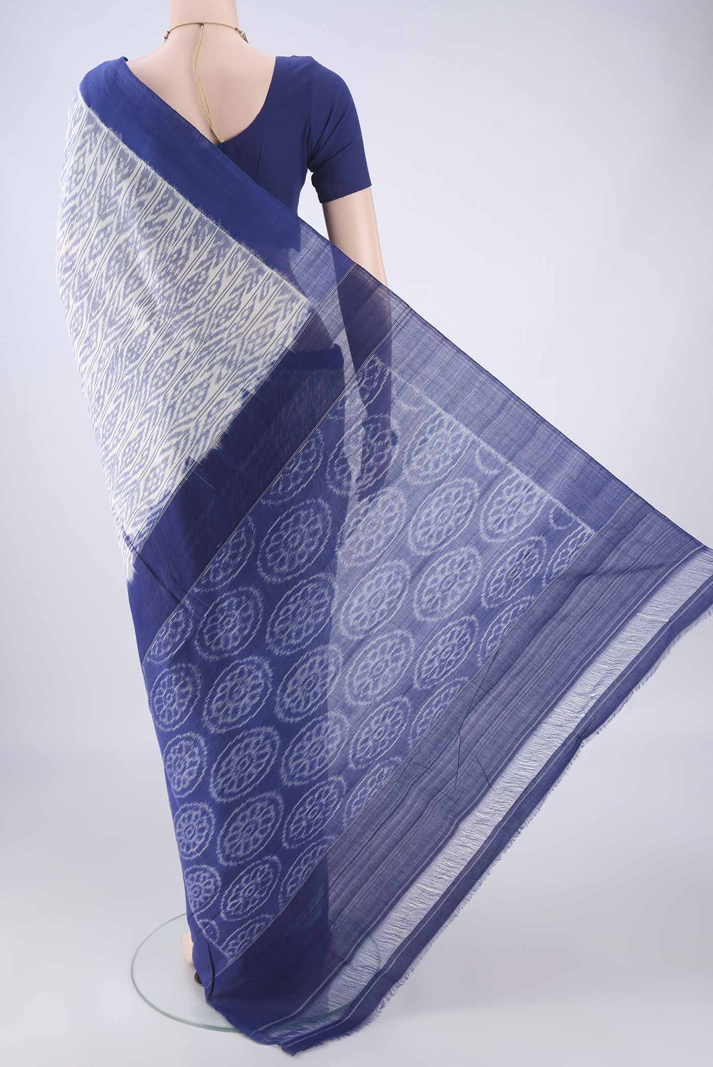 Flat view of White Pochampally Cotton Saree with Ikat design on the body and Plain Border. 