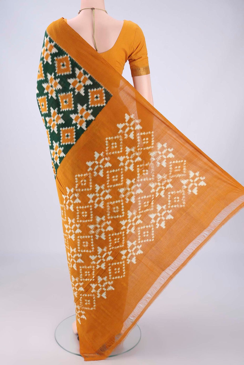 Flat view of Bottle Green Pochampally Cotton Saree with Ikat design on the body and Plain Border. 