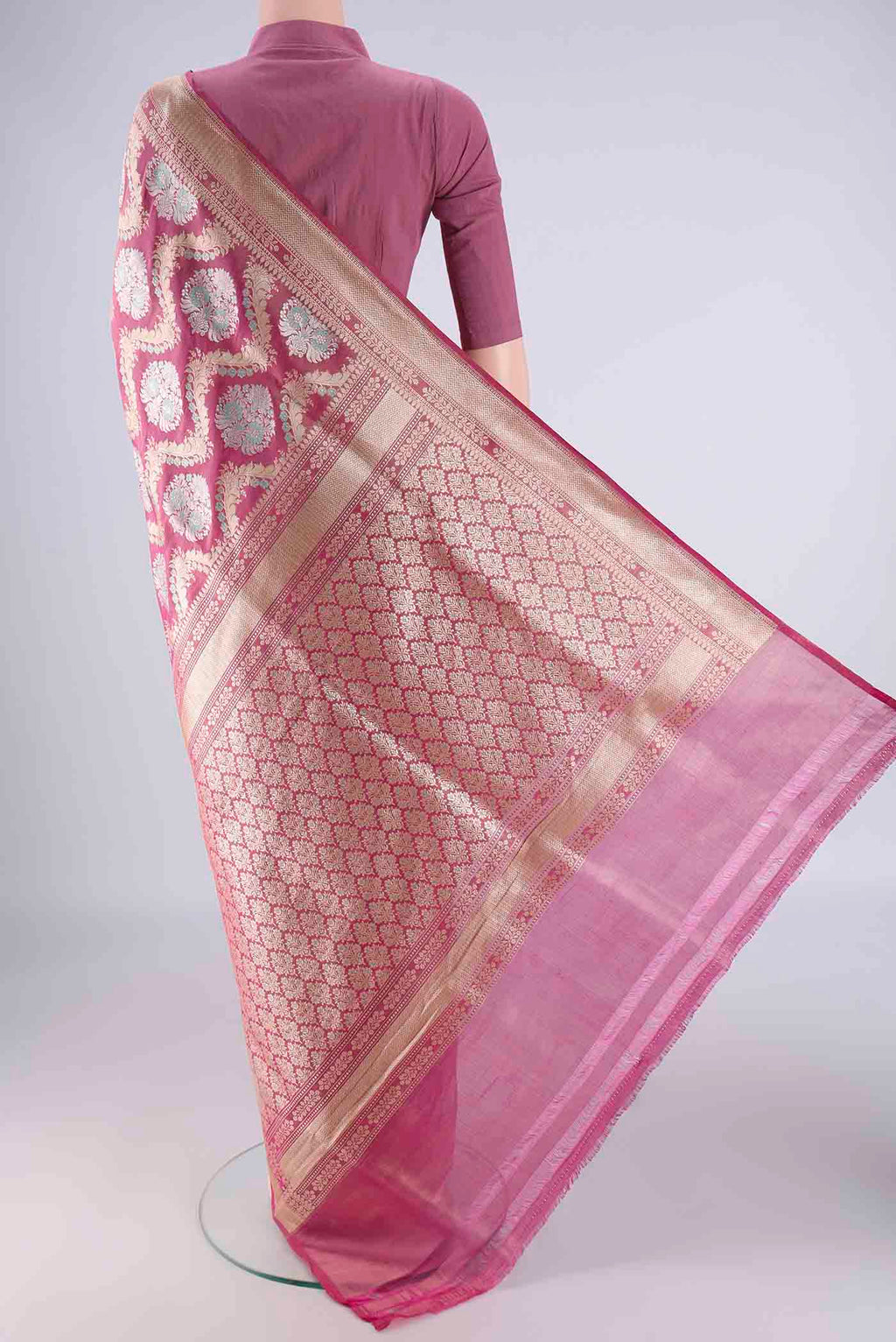 Flat view of Rani Pink Banarasi Silk Saree with Zari Brocade on the body and Zari Border. 