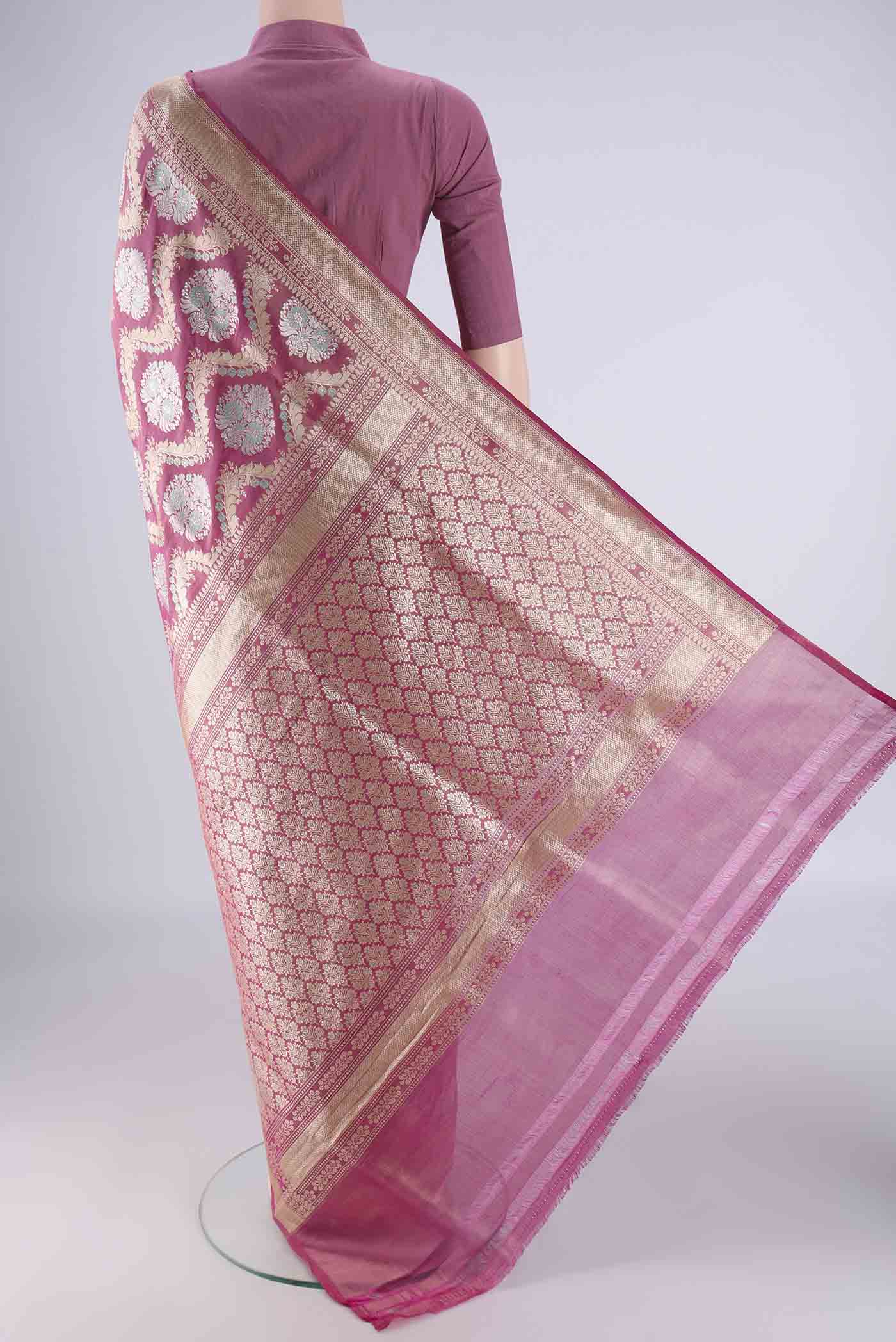 Flat view of Rani Pink Banarasi Silk Saree with Zari Brocade on the body and Zari Border. 