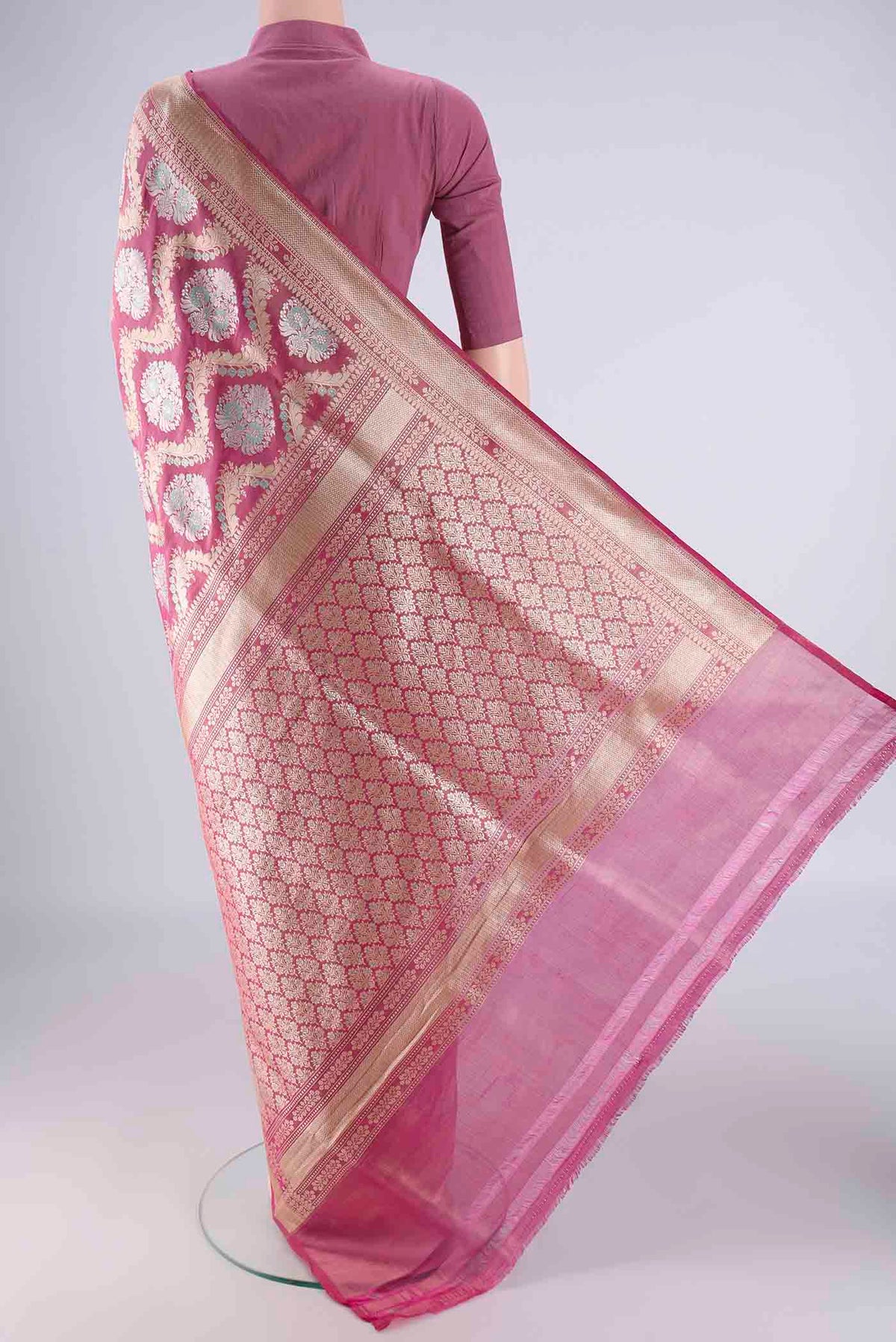 Flat view of Rani Pink Banarasi Silk Saree with Zari Brocade on the body and Zari Border. 