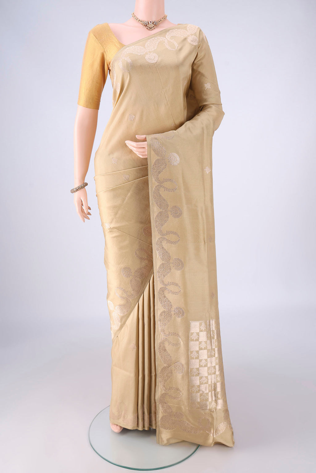 Dark Beige Banarasi Silk Saree with Zari Butta on the body and Zari Border.  displayed on a mannequin