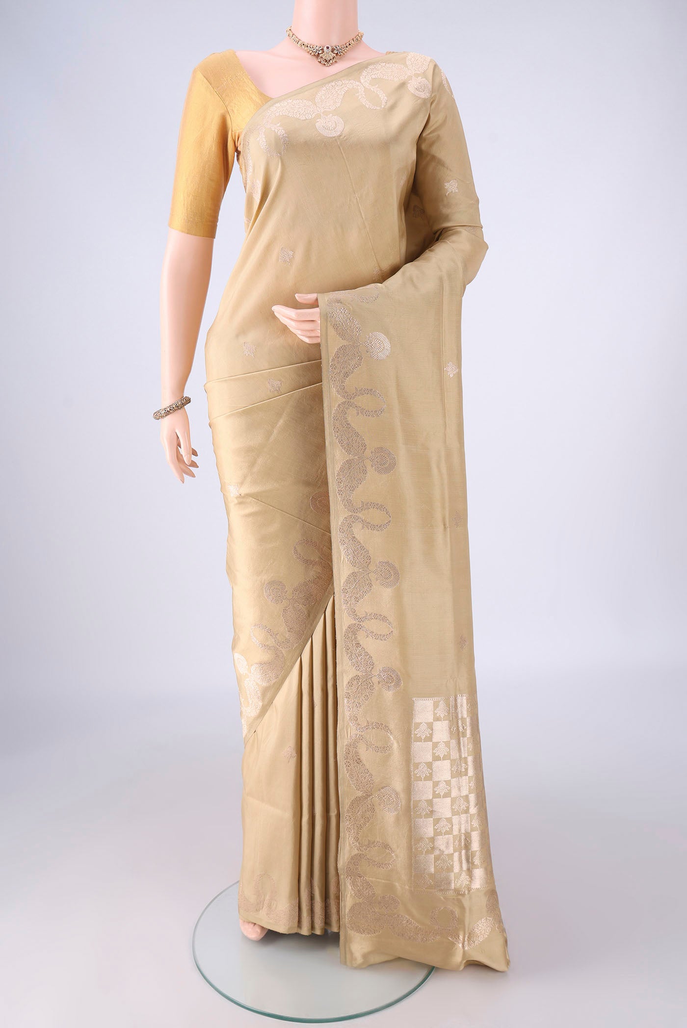Dark Beige Banarasi Silk Saree with Zari Butta on the body and Zari Border.  displayed on a mannequin