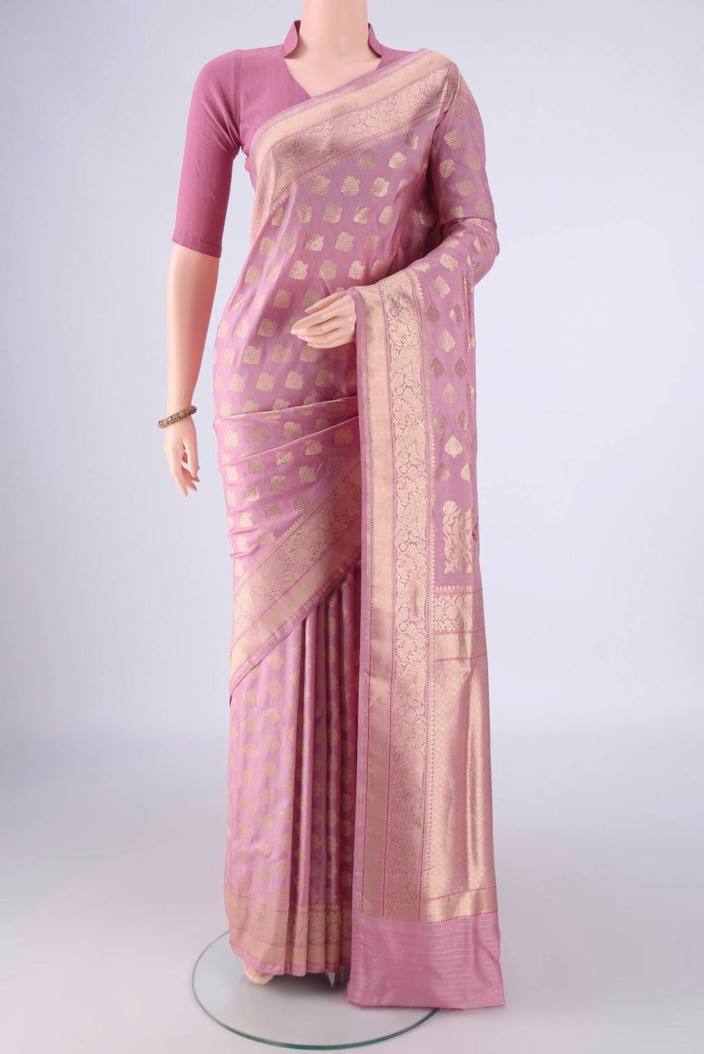 Rose pink Banarasi Silk Saree with Zari Butta on the body and Zari Border.  displayed on a mannequin