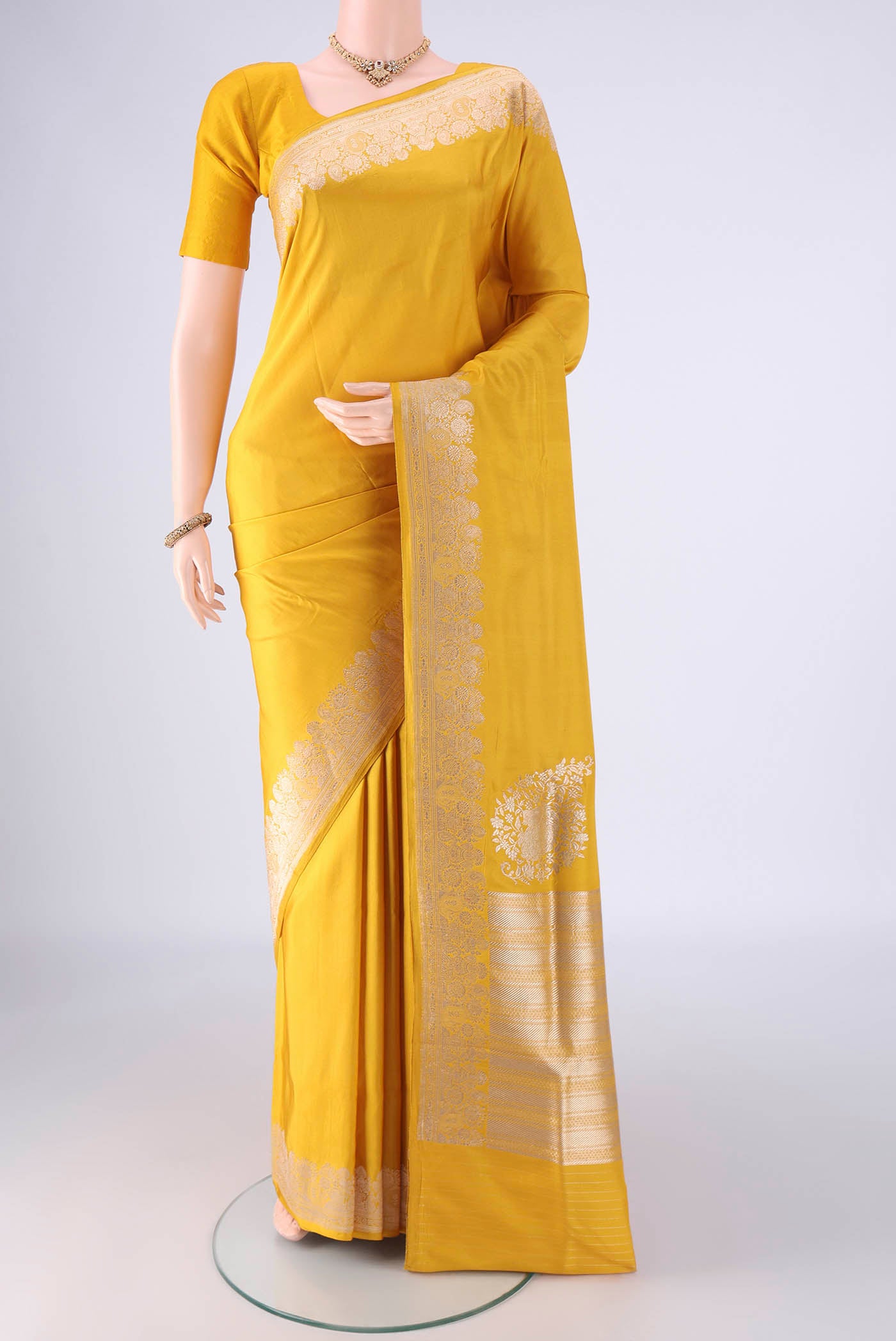 Yellow Banarasi Silk Saree with Plain Body and Zari Border.  displayed on a mannequin