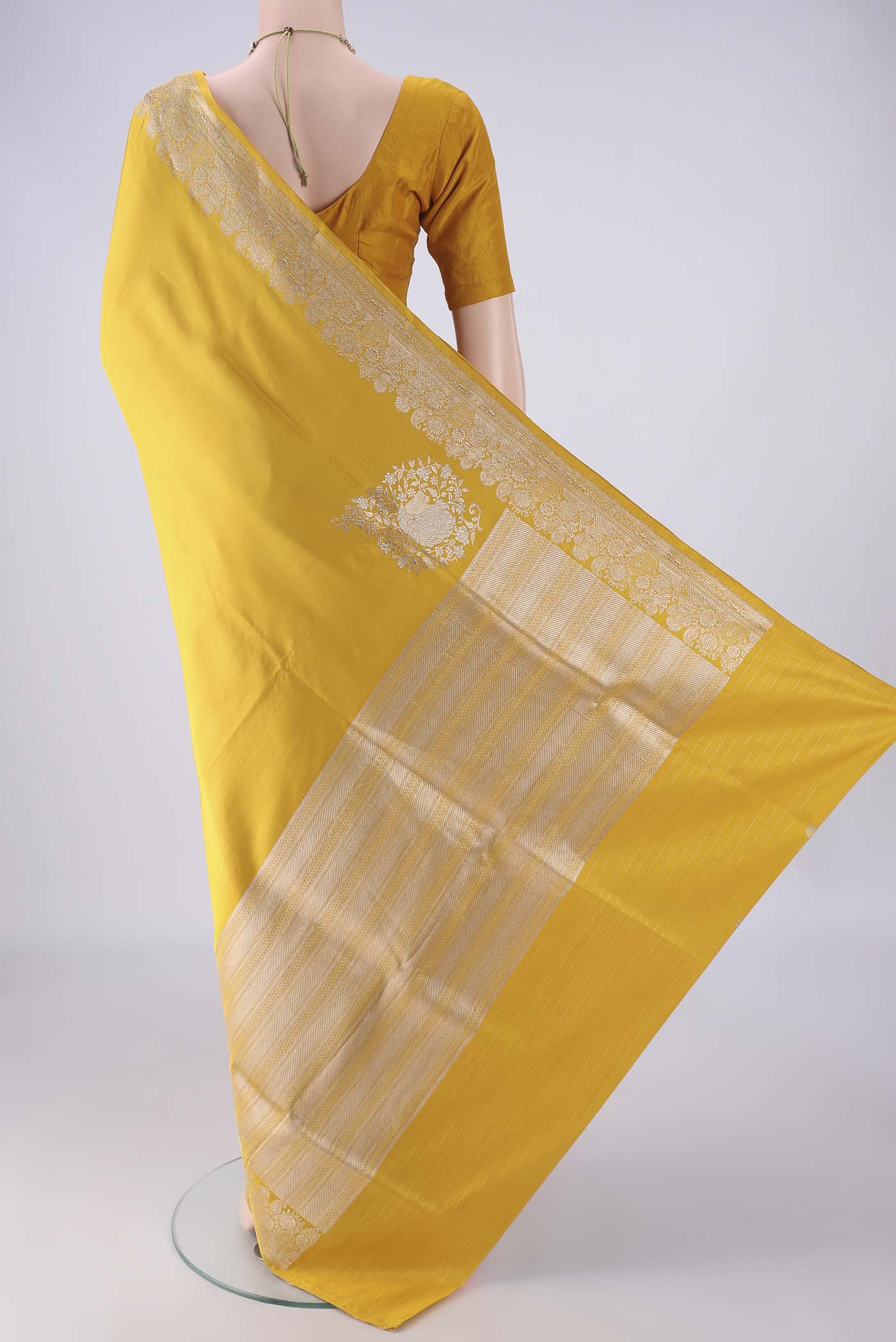 Flat view of Yellow Banarasi Silk Saree with Plain Body and Zari Border. 