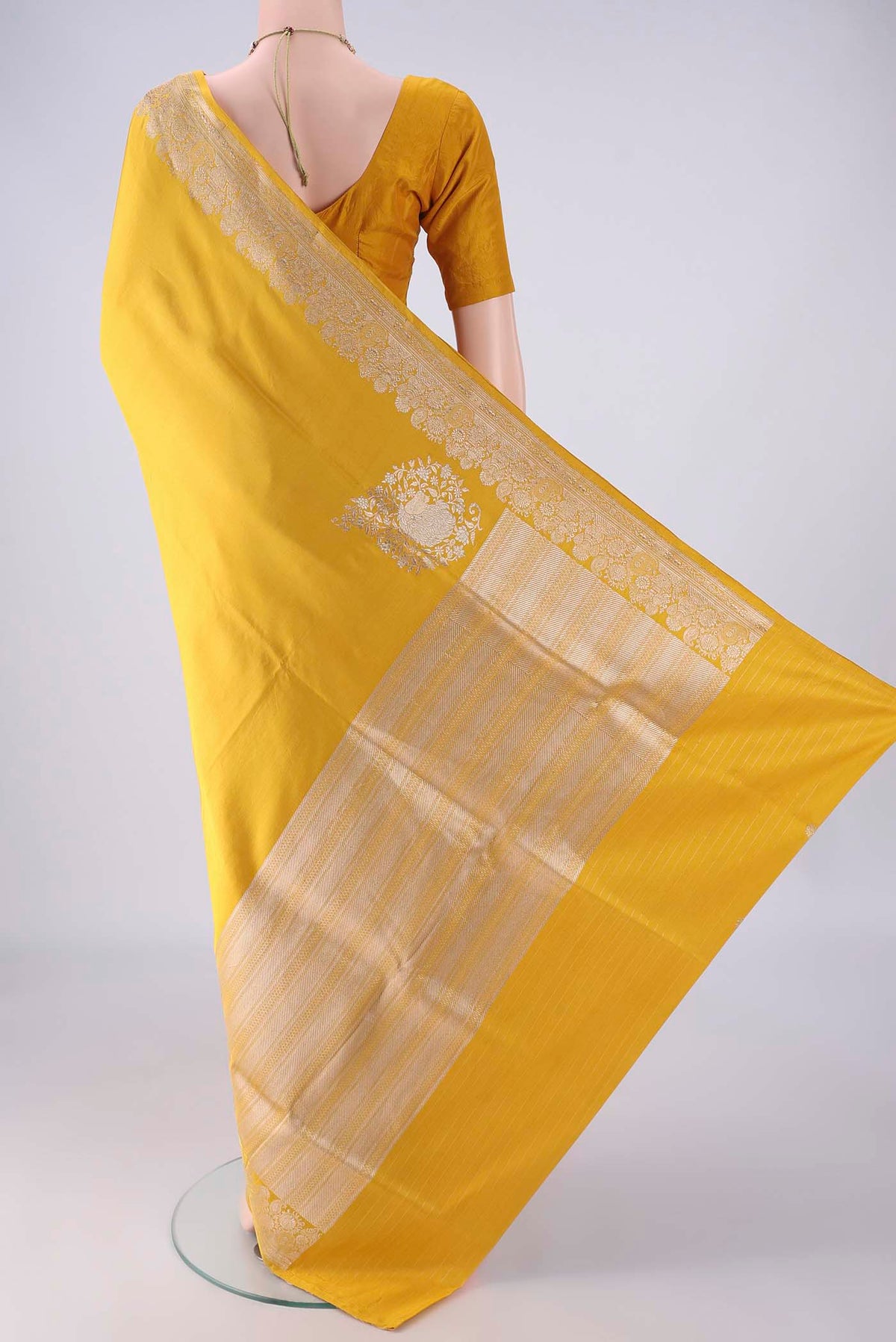 Flat view of Yellow Banarasi Silk Saree with Plain Body and Zari Border. 