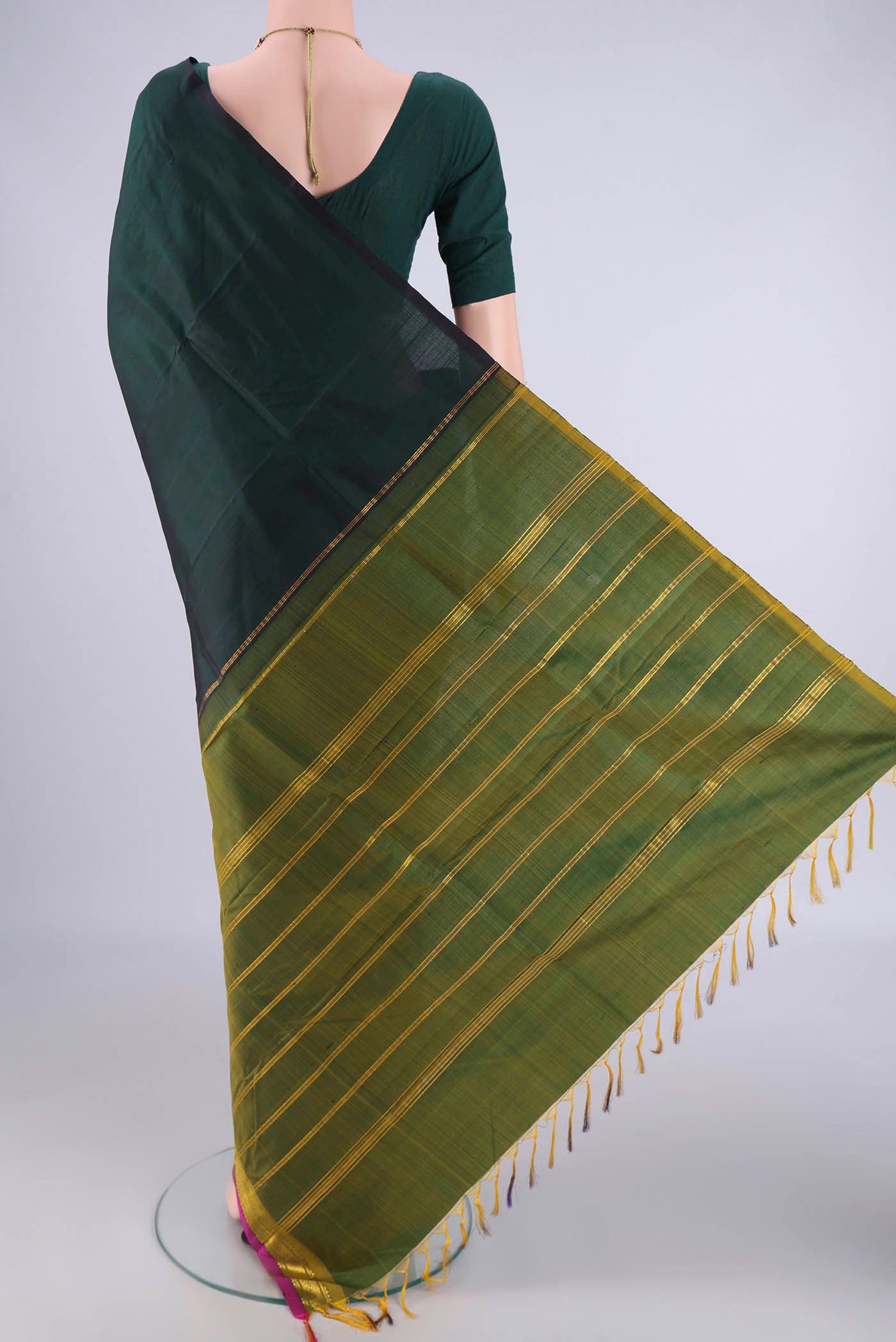Flat view of Bottle Green Kanjivaram Silk Saree with Plain Body and One Side Border. 