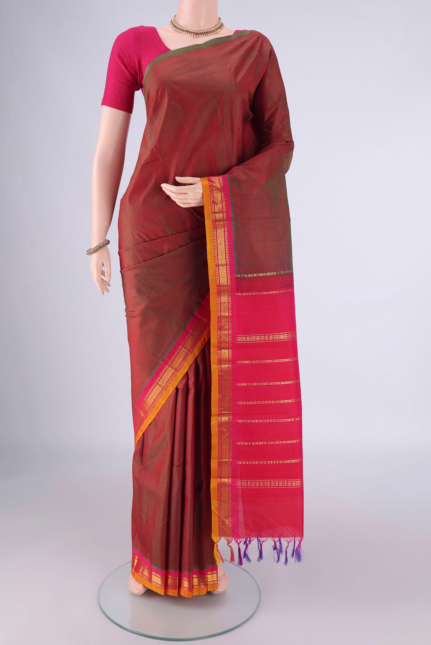 Red with Green Color Kanjivaram Silk Saree with Zari Butta on the body and One Side Border.  displayed on a mannequin