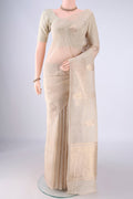 Beige Linen Saree with Zari Butta on the body and Thin Zari Line.  displayed on a mannequin
