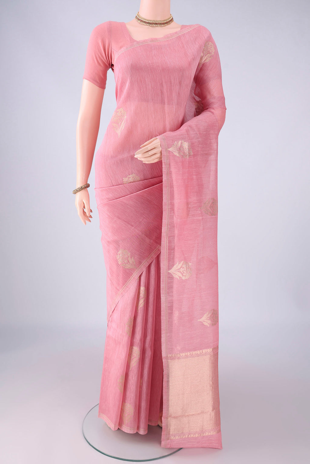 Rose pink Linen Saree with Zari Butta on the body and Thin Zari Line.  displayed on a mannequin