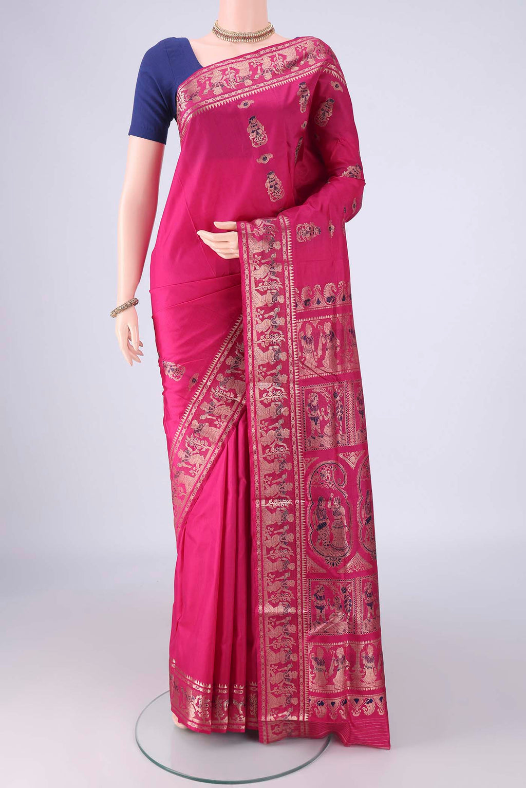 Rani Pink Baluchari Silk Saree with Zari And Thread Butta on the body and Zari Border.  displayed on a mannequin