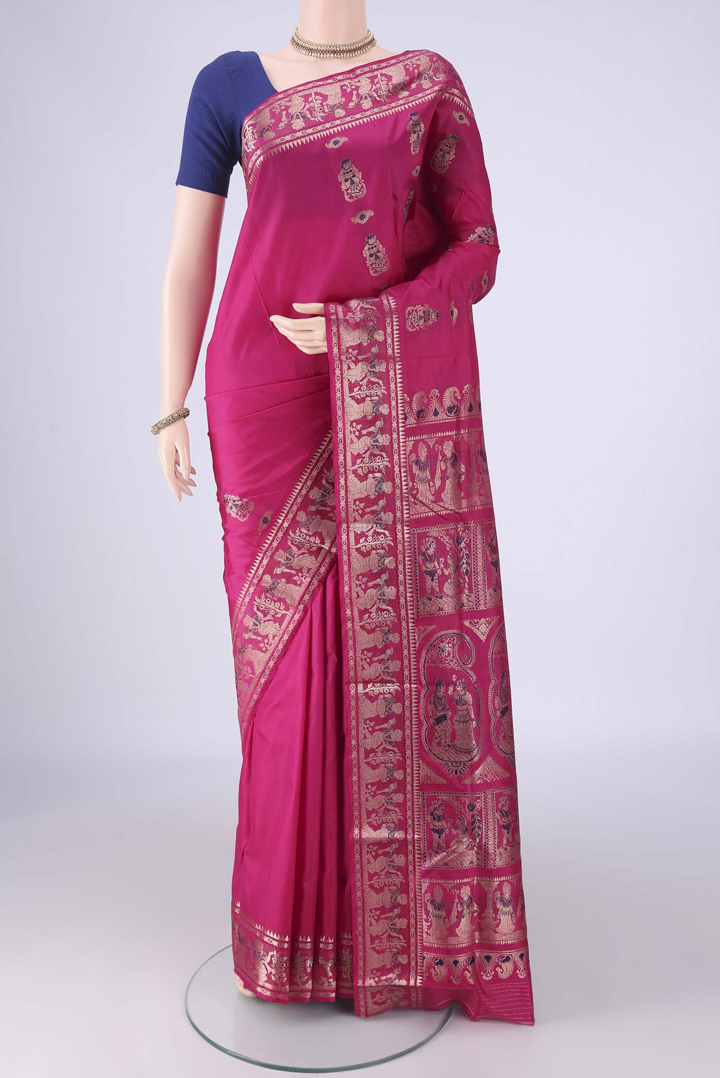 Rani Pink Baluchari Silk Saree with Zari And Thread Butta on the body and Zari Border.  displayed on a mannequin