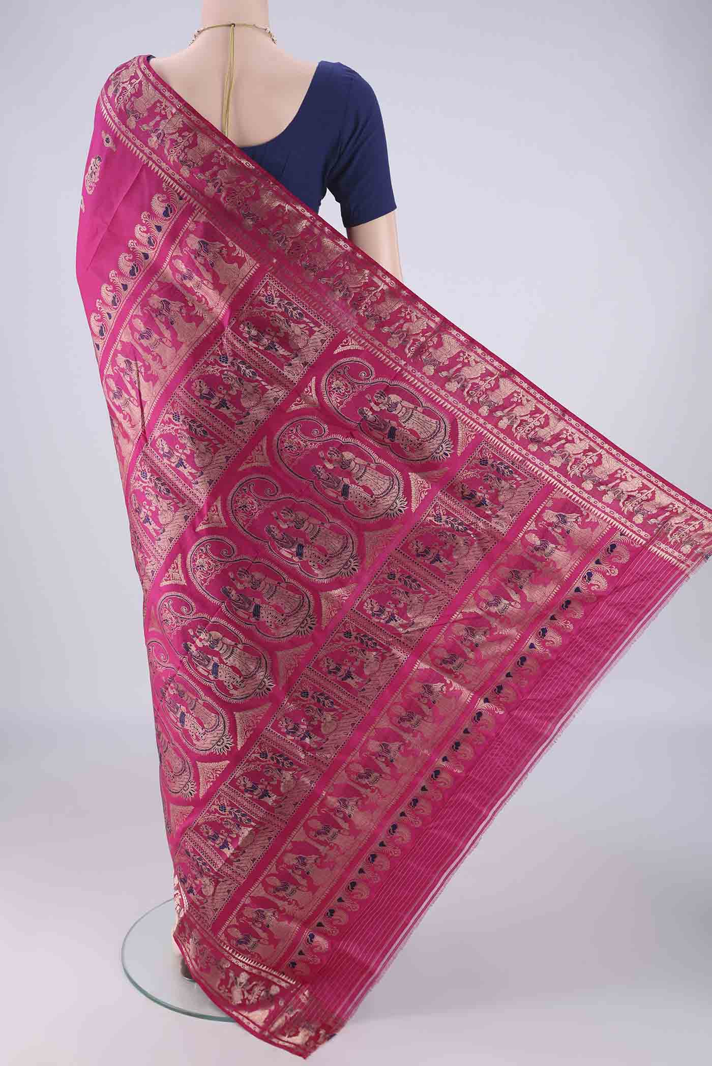 Flat view of Rani Pink Baluchari Silk Saree with Zari And Thread Butta on the body and Zari Border. 