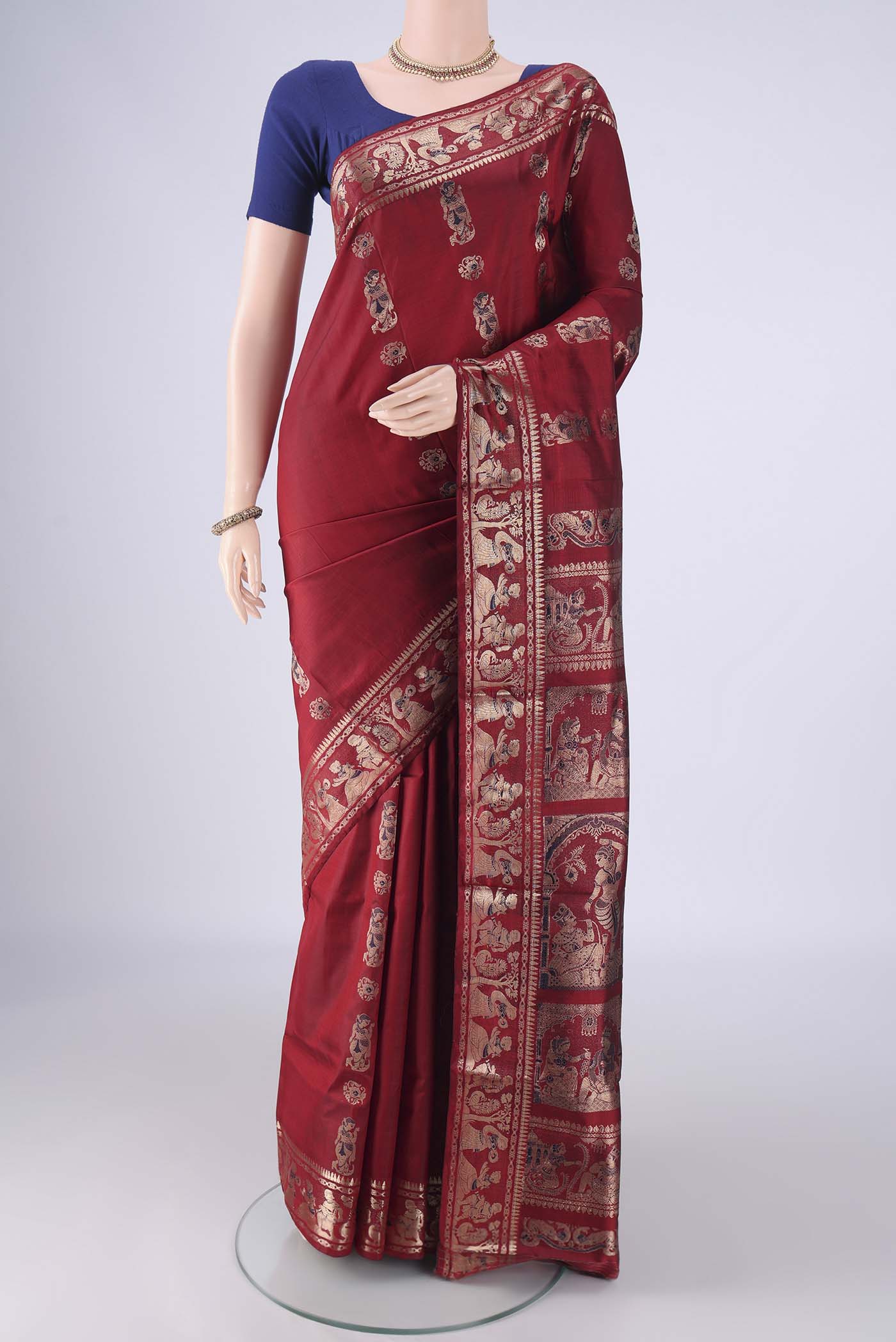Maroon Baluchari Silk Saree with Zari And Thread Butta on the body and Zari And Thread Border.  displayed on a mannequin