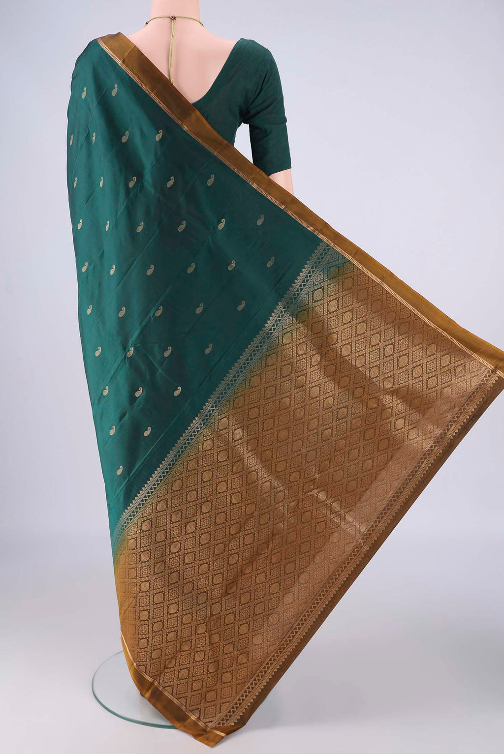 Flat view of Bottle Green Kanjivaram Silk Saree with Zari Butta on the body and Plain Border. 