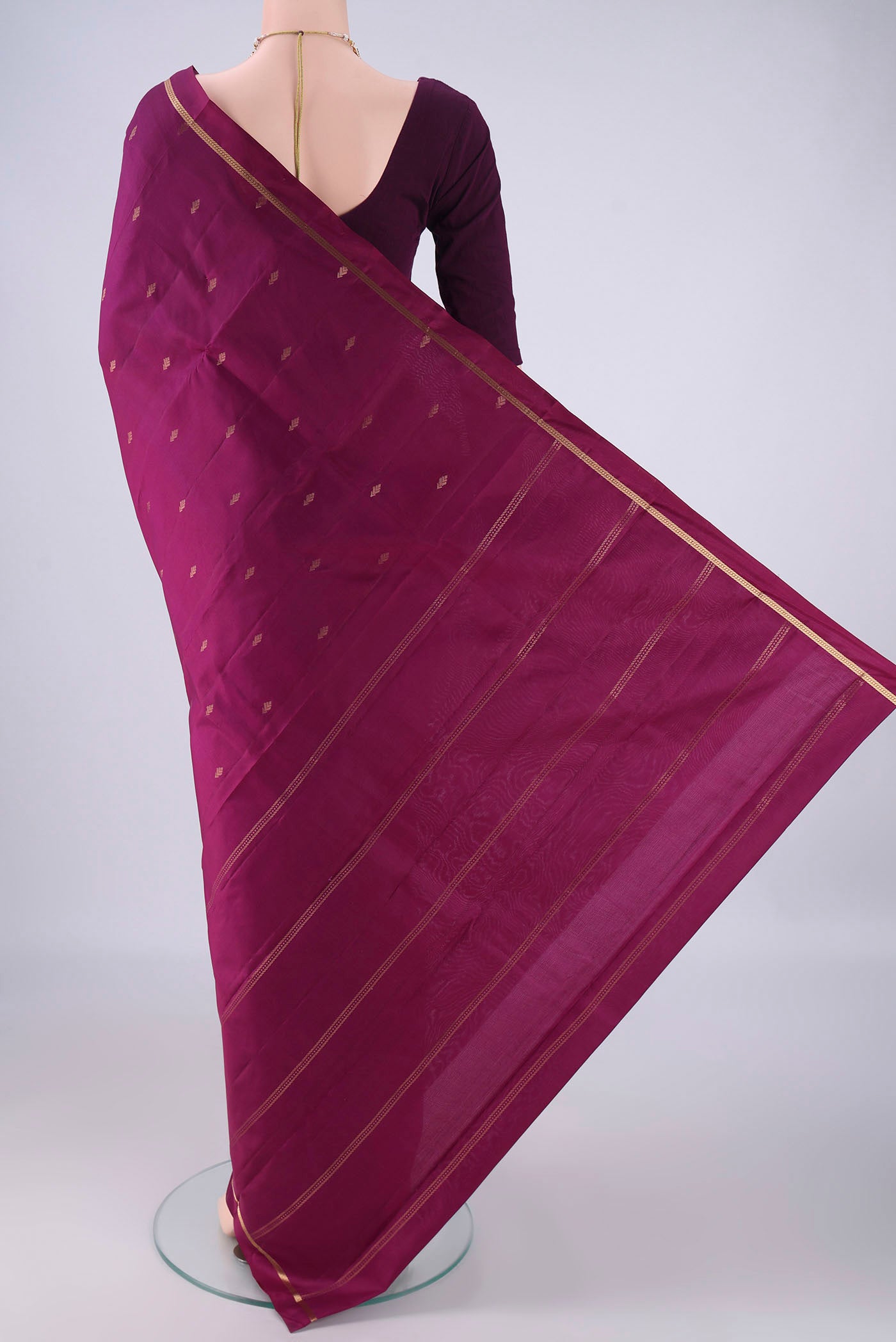 Flat view of Magenta Kanjivaram Silk Saree with Zari Butta on the body and Plain Border. 