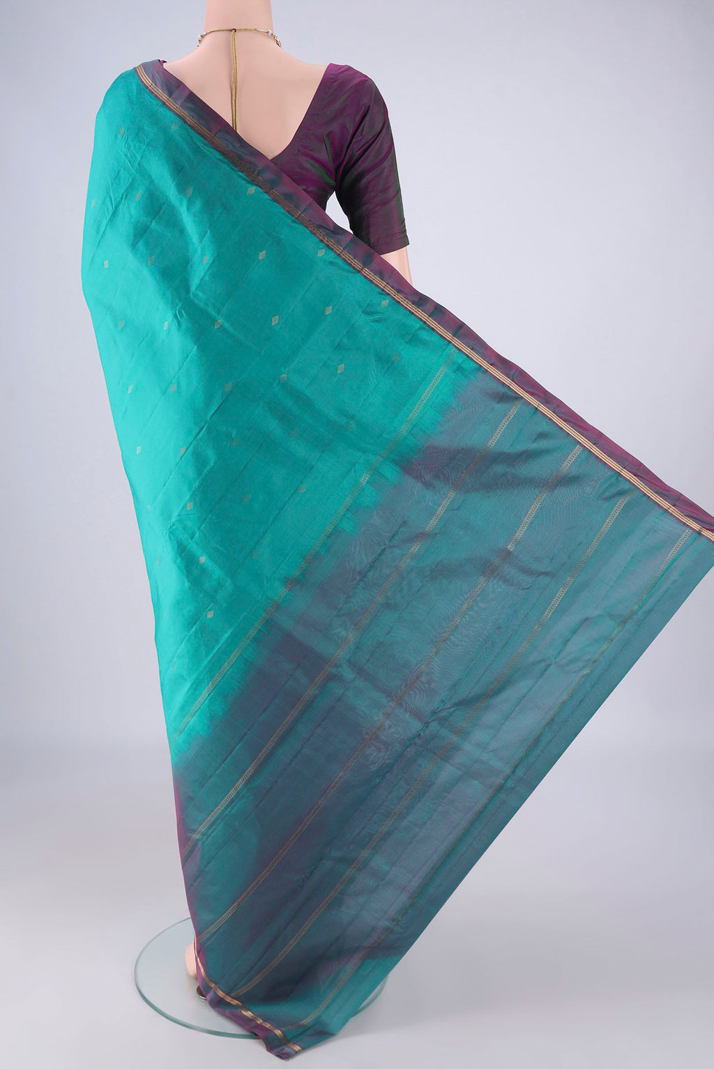 Flat view of Turquoise Kanjivaram Silk Saree with Zari Butta on the body and Plain Border. 