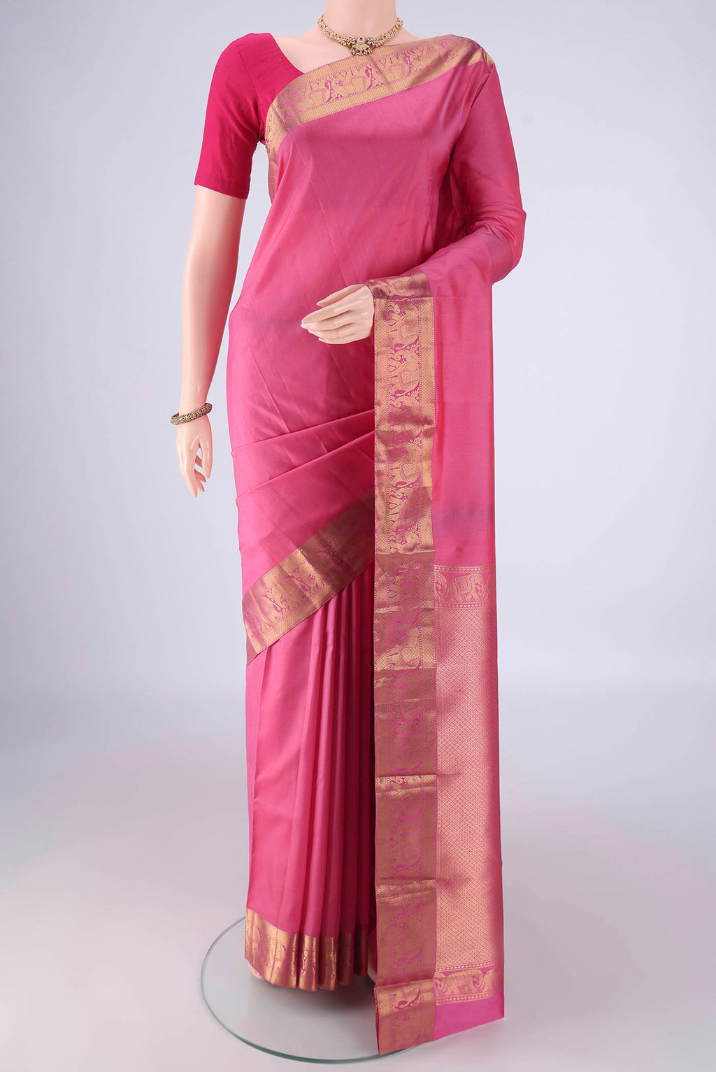 Pink Kanjivaram Silk Saree with Plain Body and Zari Border.  displayed on a mannequin