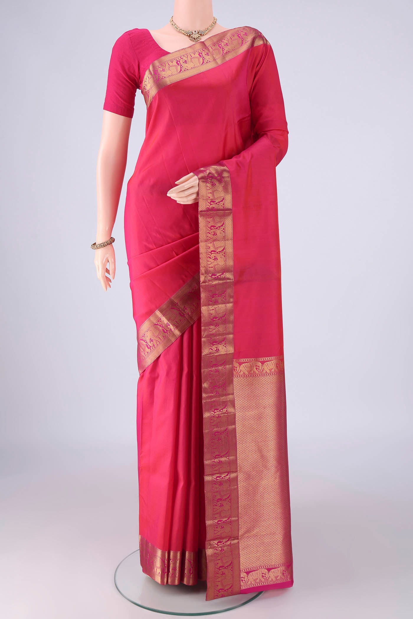Pink Kanjivaram Silk Saree with Plain Body and Zari Border.  displayed on a mannequin