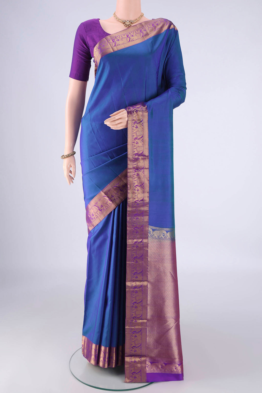 Royal Blue Kanjivaram Silk Saree with Plain Body and Zari Border.  displayed on a mannequin