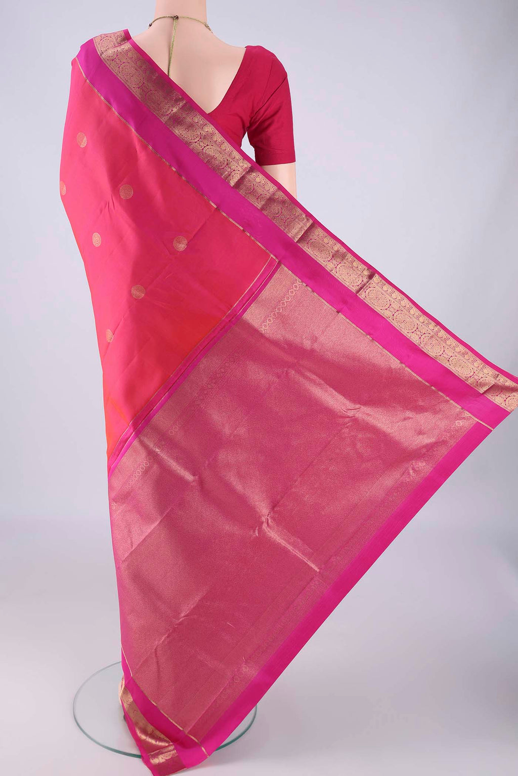 Flat view of Pink Kanchipuram Silk Saree with Zari Butta on the body and Zari Border. 